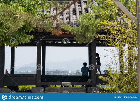 The silhouette of the father and son on the cool breeze pavilion..